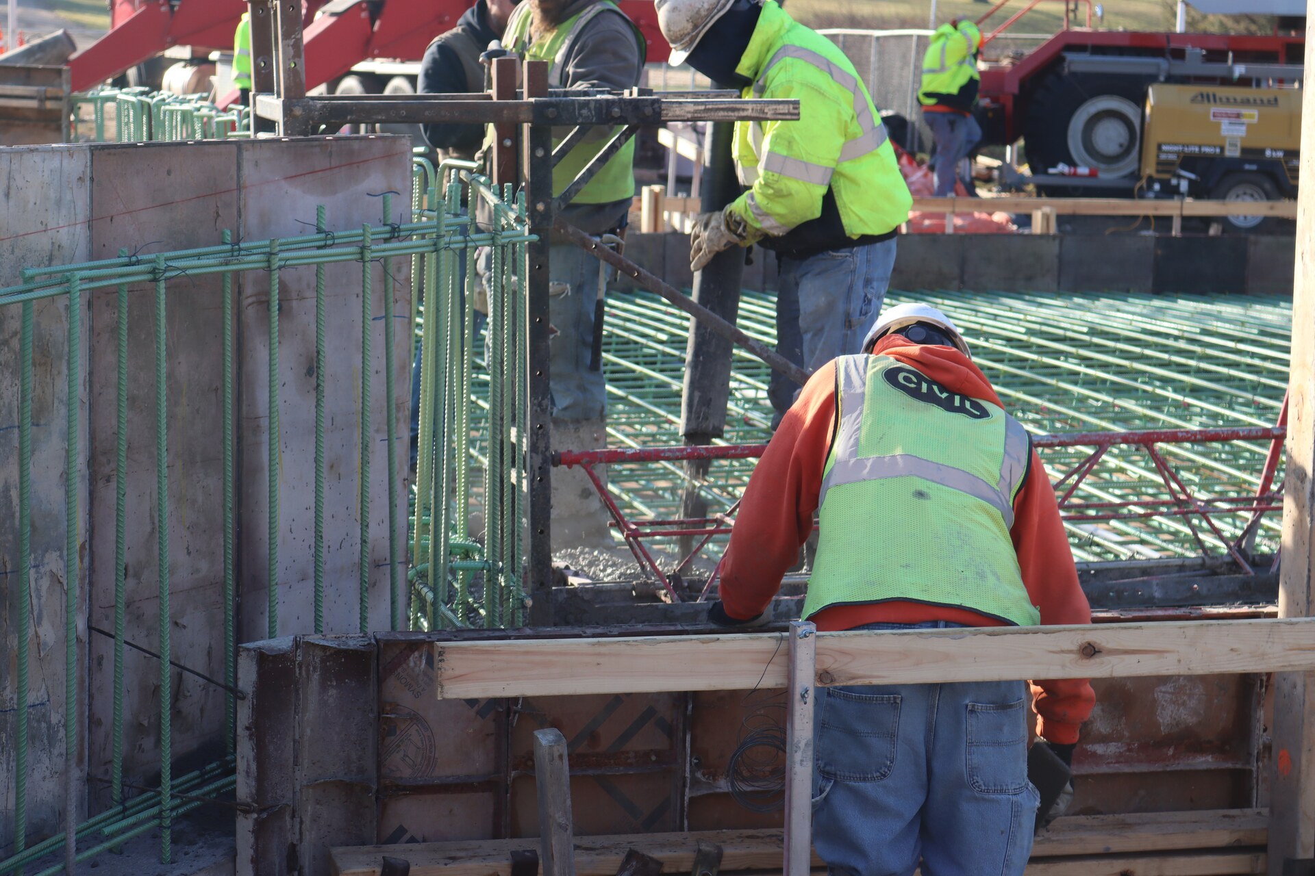Concrete workers around reinforced concrete forms