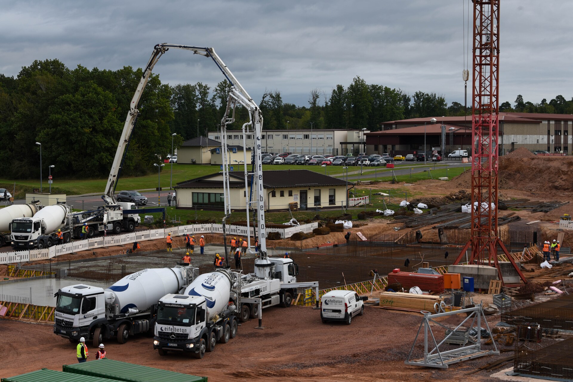 Concrete construction site with concrete trucks and workers